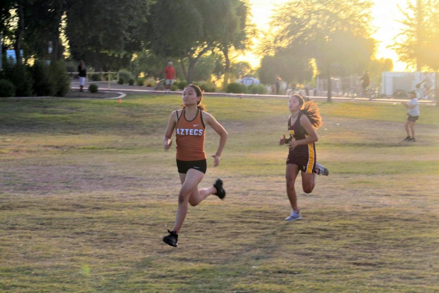 Aztec Gisell Gallegos sprints toward the finish line at the district championships.